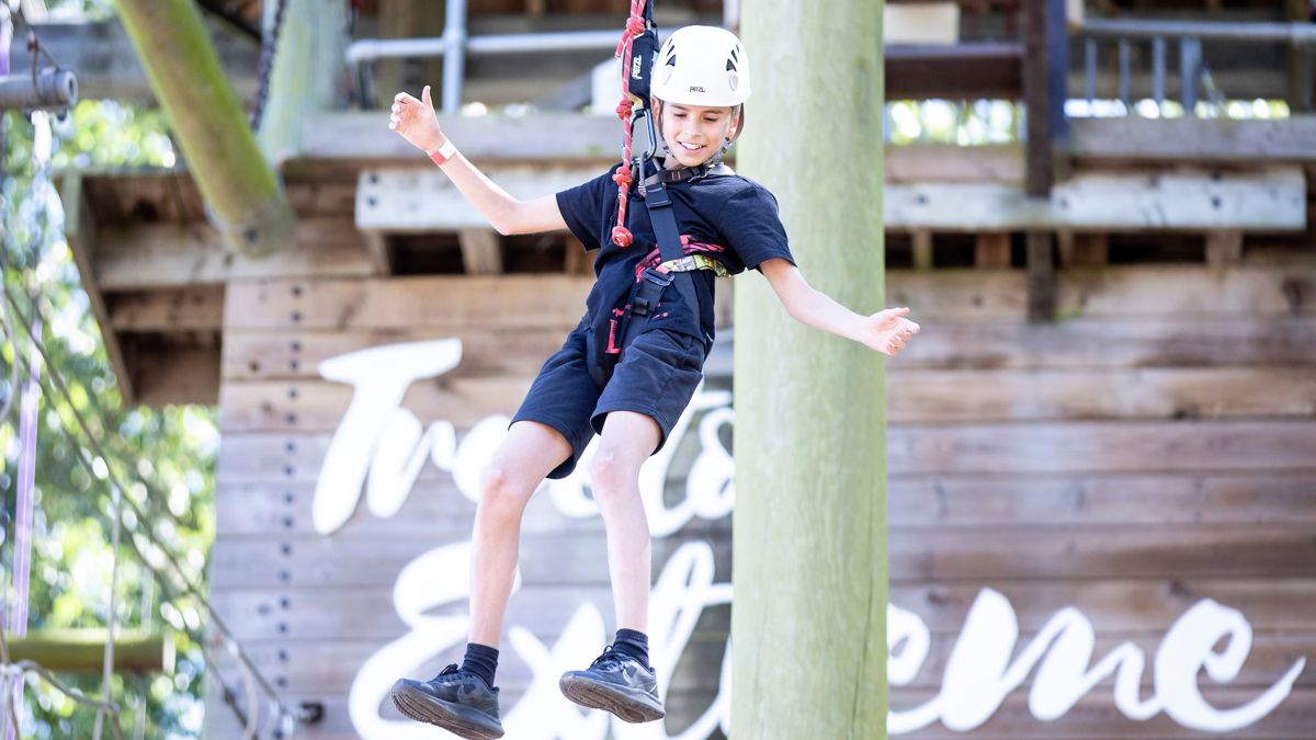 Child on Treetop Drop on high ropes course at Willen Lake