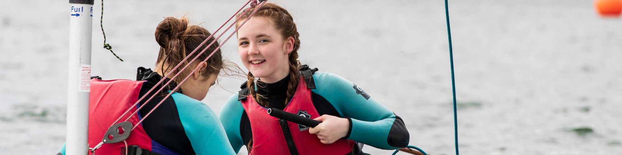 Two children taking part in a sailing session at Willen Lake in Milton Keynes