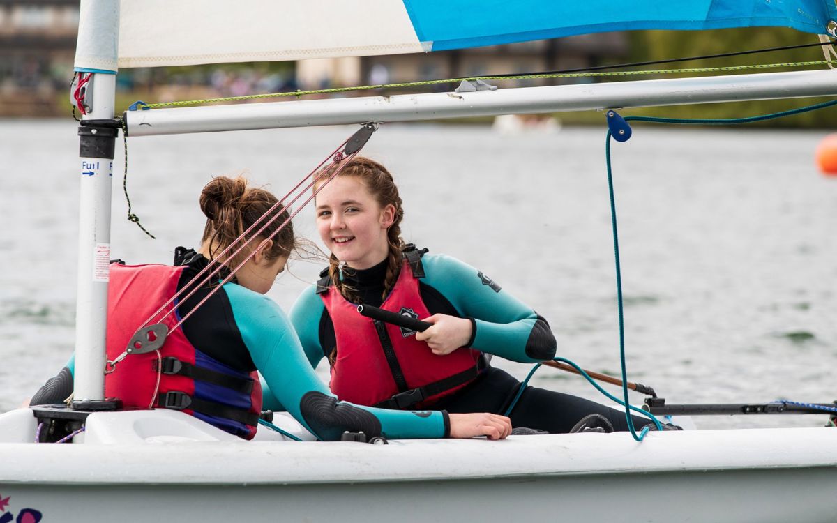 Two children taking part in a sailing session at Willen Lake in Milton Keynes