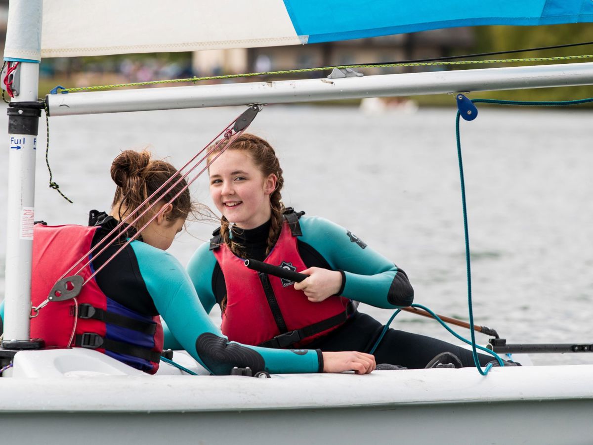 Two children taking part in a sailing session at Willen Lake in Milton Keynes