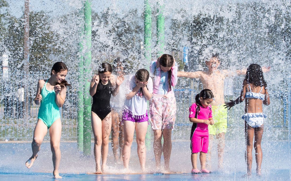 Group of children stood under splash feature