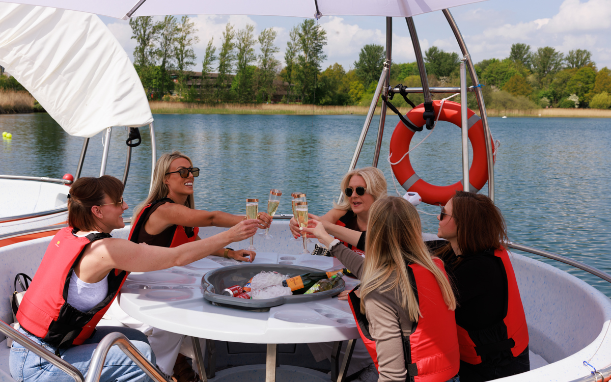 Group of people clinking glasses on a Cabana Boat