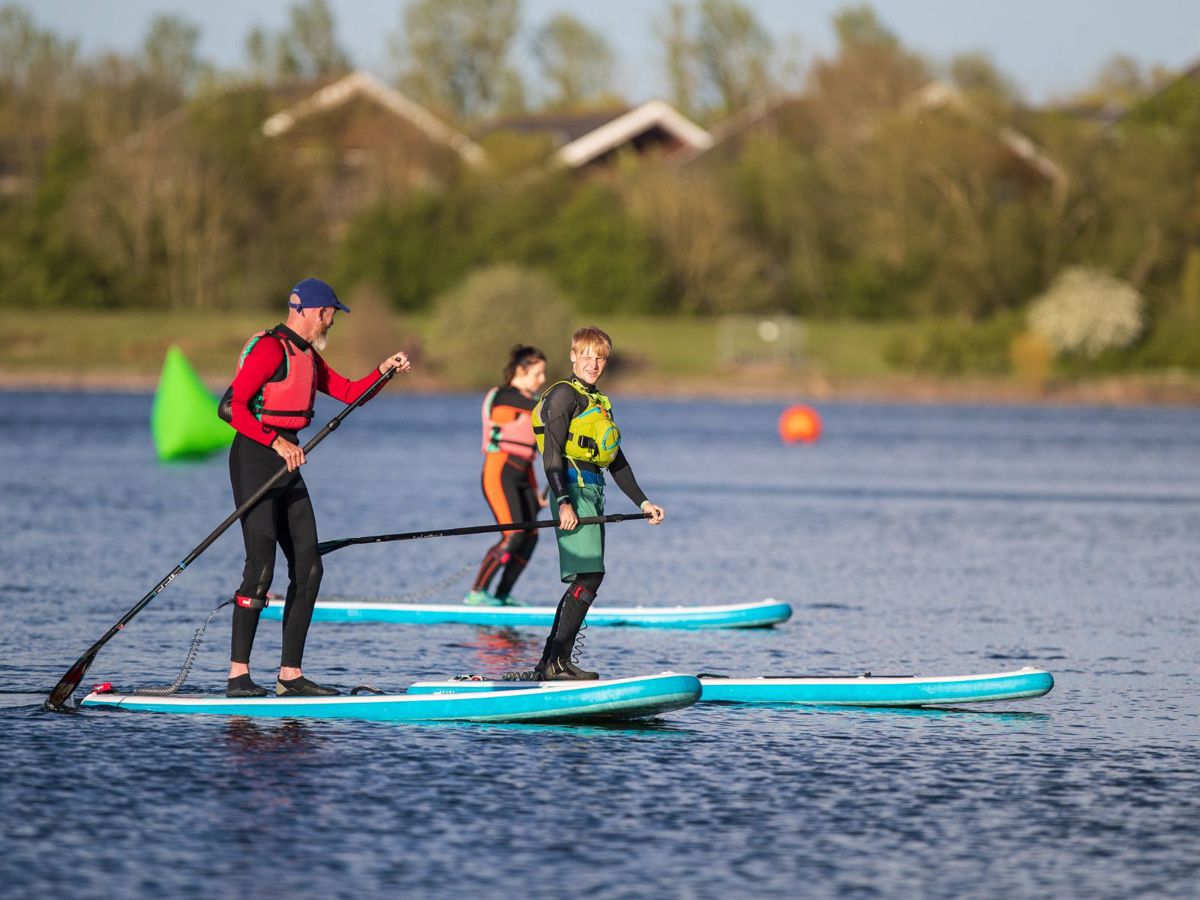 People paddleboarding on Willen Lake in Milton Keynes