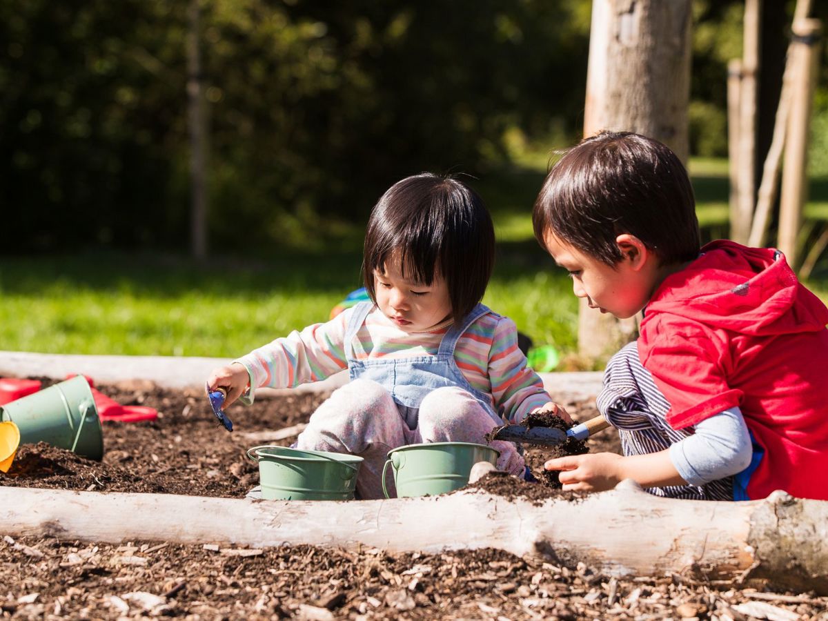 Two children playing in outdoor area