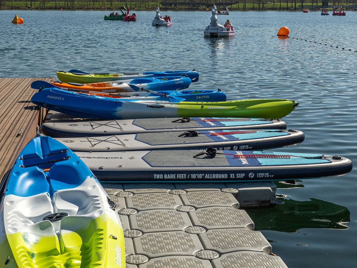 Kayak and paddleboards next to water at Willen Lake