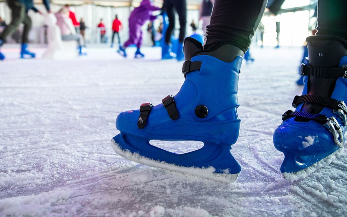 Blue ice skates on skating rink