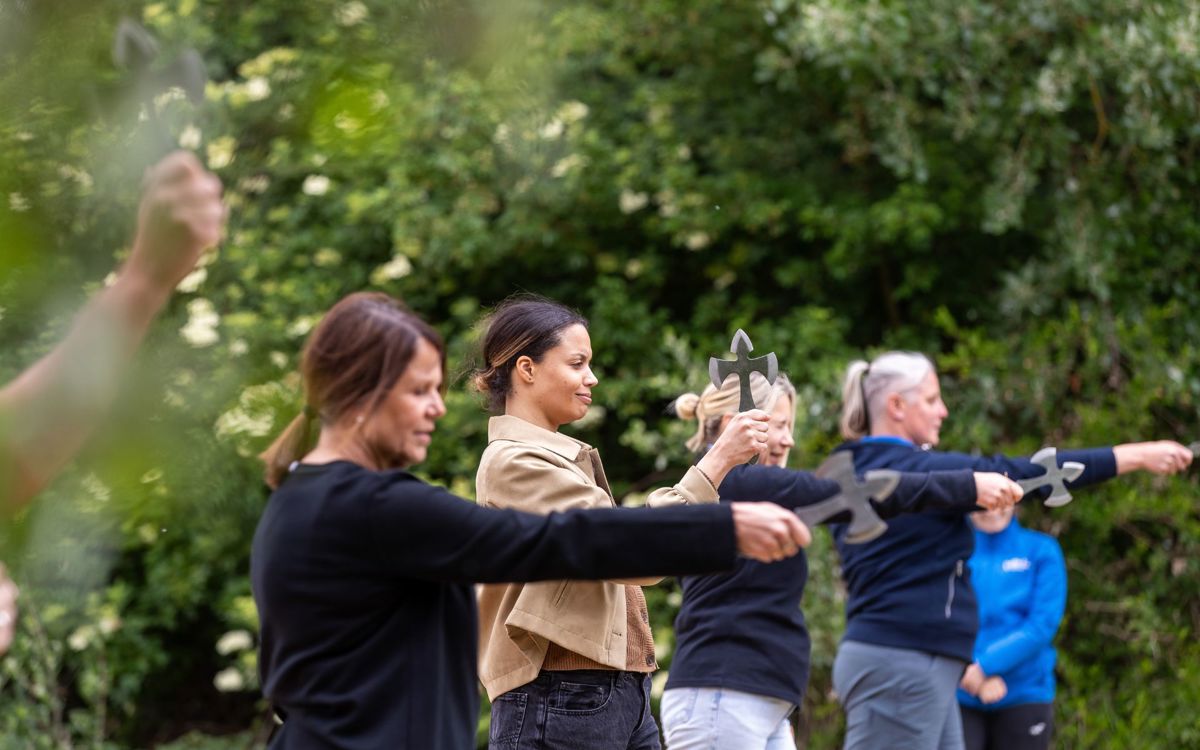 Group of people practicing their aim with axes