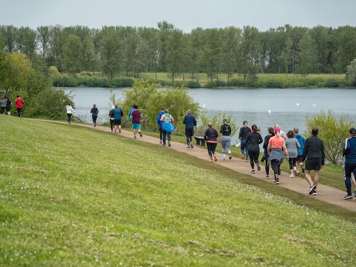 People running along the lakeside at Willen Lake in Milton Keynes 